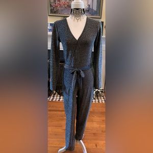 ong sleeve black sparkly jumpsuit with criss cross, button enclosure “V” front.